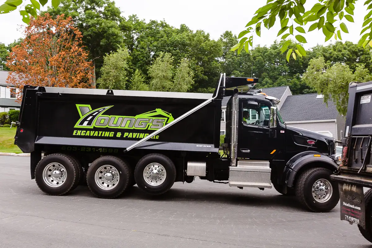 Young's Excavating & Paving LLC dump truck with the company logo, 37 Washington St, Penacook, NH.