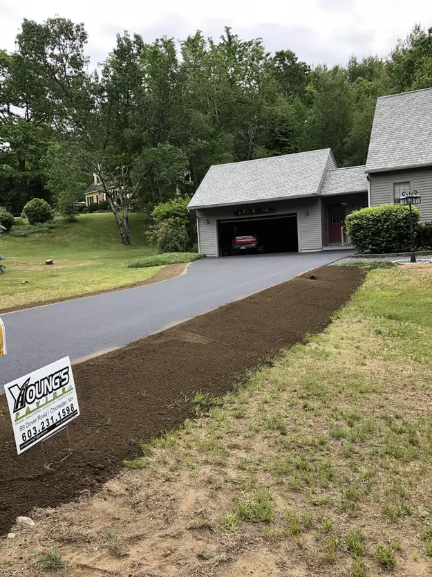 Freshly paved asphalt driveway running up to an open two bay garage, Young's Excavating & Paving LLC, 37 Washington St, Penacook, Concord, NH.