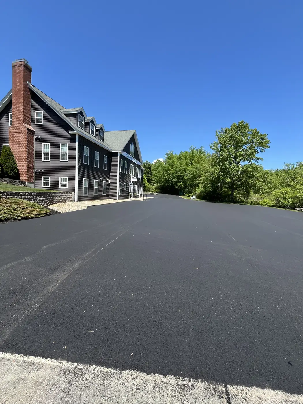Finished asphalt overlay on a commercial back lot beside a multi unit building, Young's Excavating & Paving LLC, 37 Washington St, Penacook, Concord, NH.