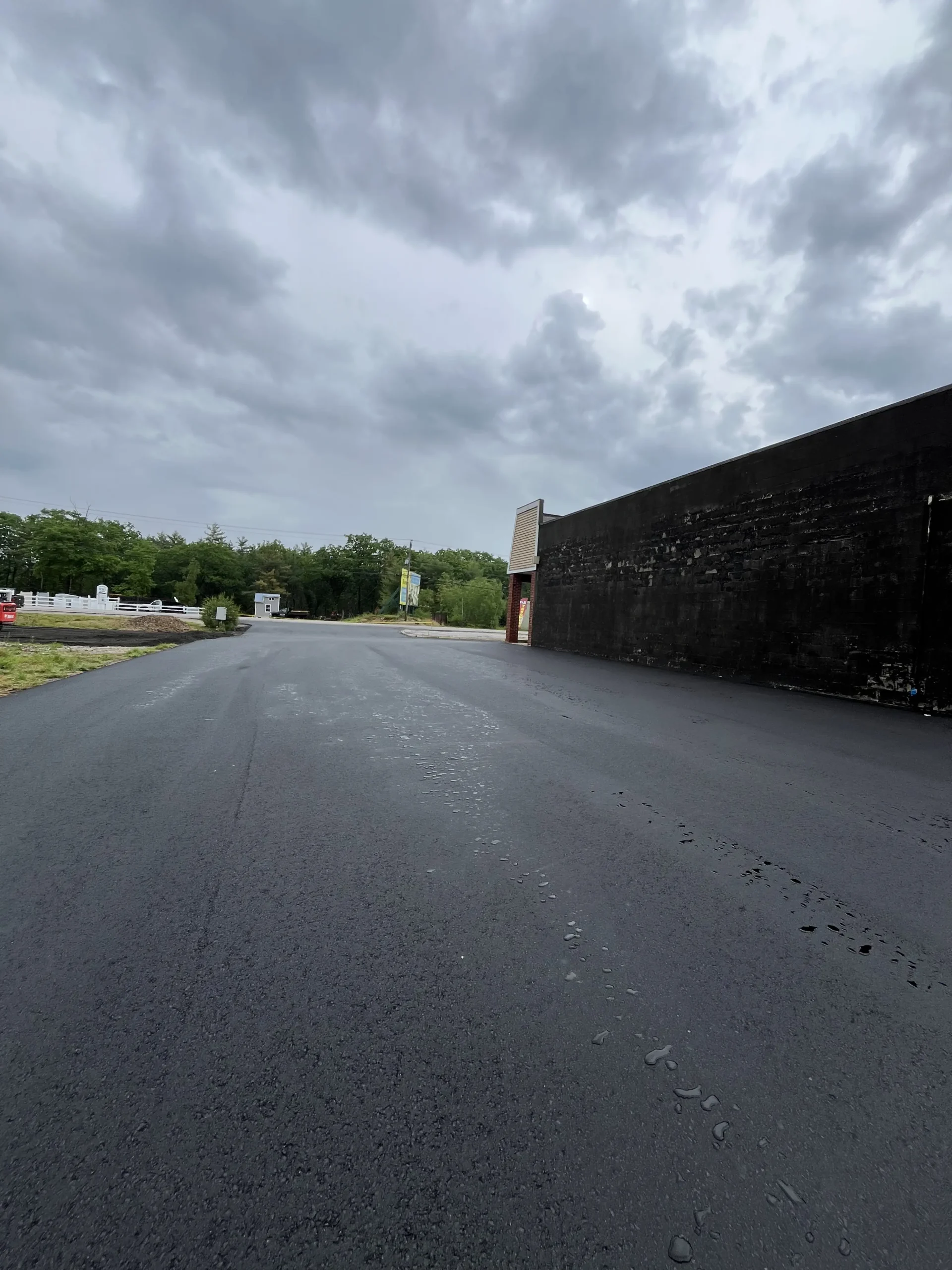New asphalt surface across a commercial parking lot after full depth reclamation in New Hampshire, Young's Excavating & Paving LLC, 37 Washington St, Penacook, NH.