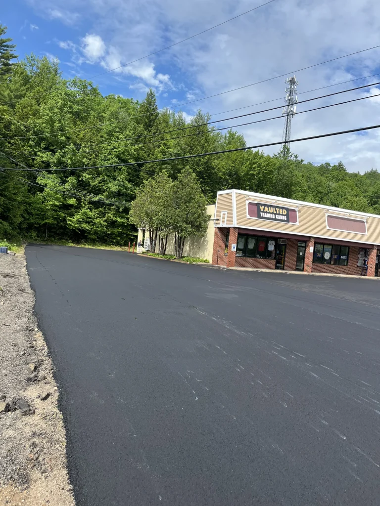 Second view of the finished parking lot at 680 White Mountain Highway in Tamworth, New Hampshire, with new asphalt in the foreground, Young's Excavating & Paving LLC, 37 Washington St, Penacook, NH.