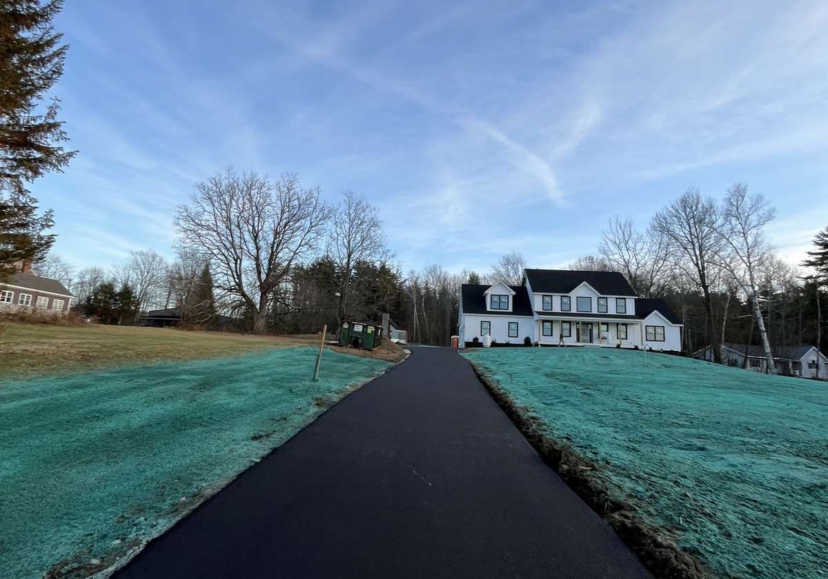 Finished asphalt driveway with hydroseeded edges, Young's Excavating & Paving LLC, Penacook, New Hampshire.