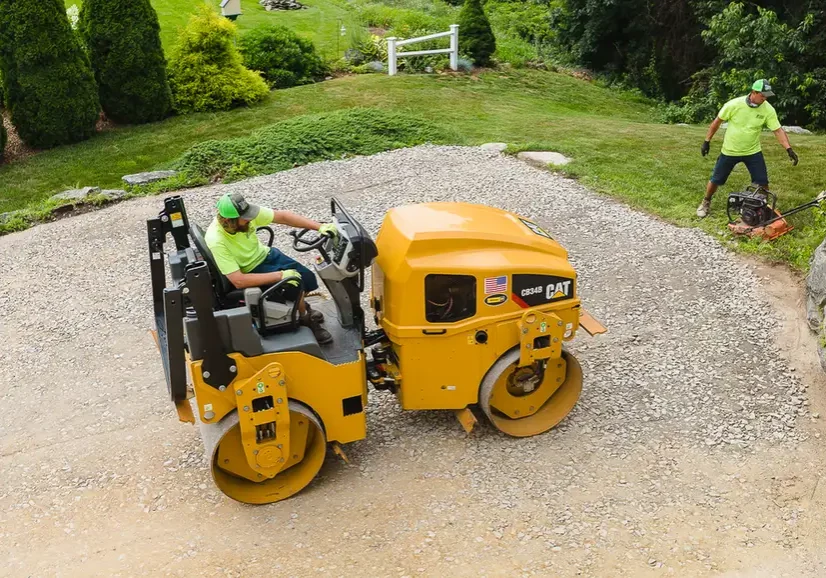 Roller compacting the base ahead of asphalt placement, Young's Excavating & Paving LLC, 37 Washington St, Penacook, NH.