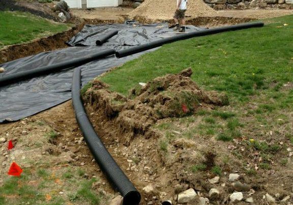 Drainage trench with corrugated pipe installed during site work by Young's Excavating & Paving LLC, 37 Washington St, Penacook, NH.