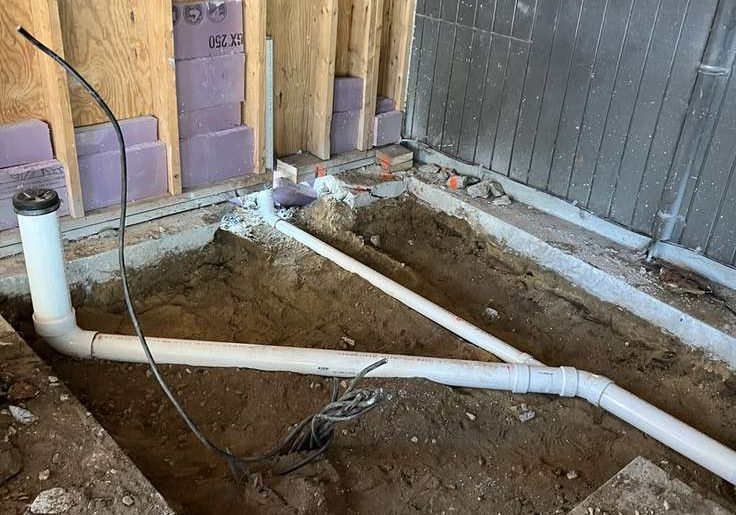 Foundation excavation with drainage piping in place, Young's Excavating & Paving LLC, Penacook, New Hampshire.